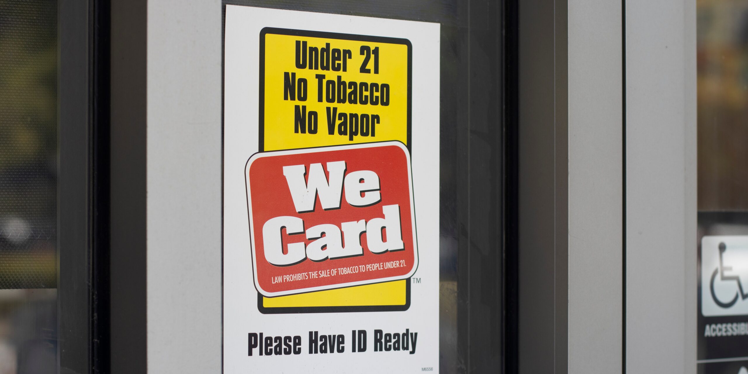 Image of a sign on a store stating We Card