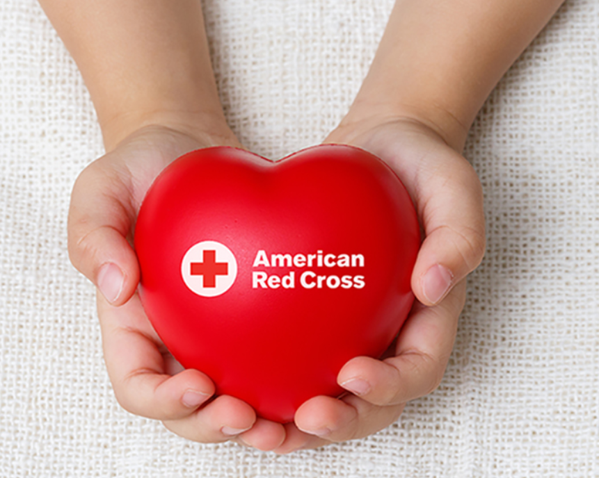 Decorative banner of two hands holding a heart with American Red Cross logo