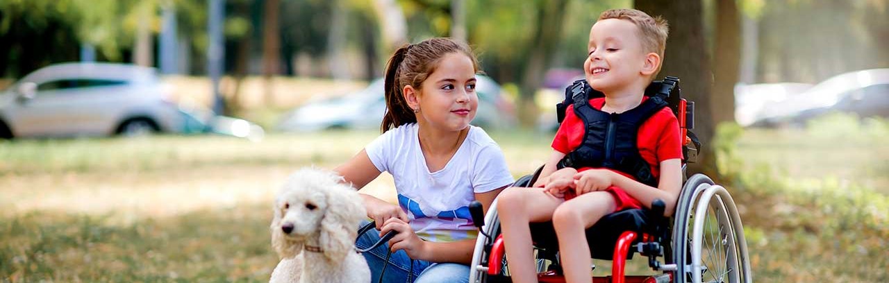 Child in wheelchair with friend and dog